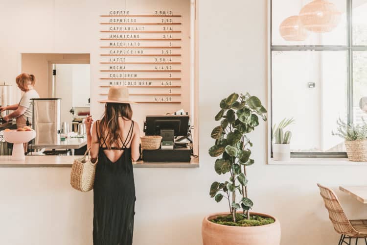 girl standing in coffee shop, ordering