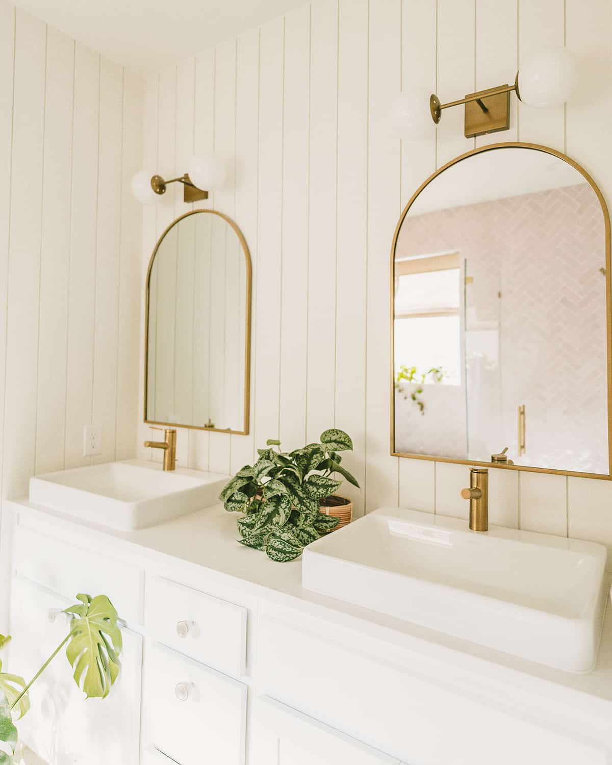 Gold mirrors with rectangle vessel sink and brass faucets